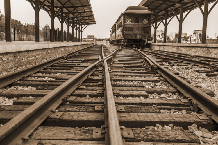 Vintage train carriage at a railway station platform.