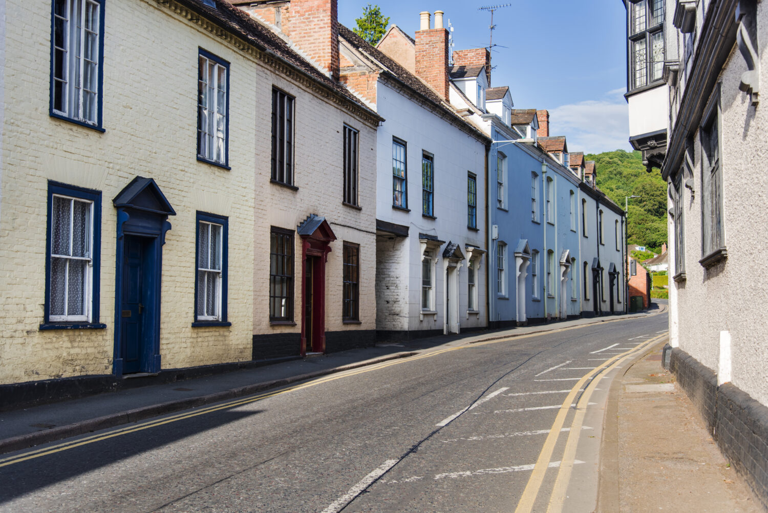 Residential street lined with traditional terraced houses.